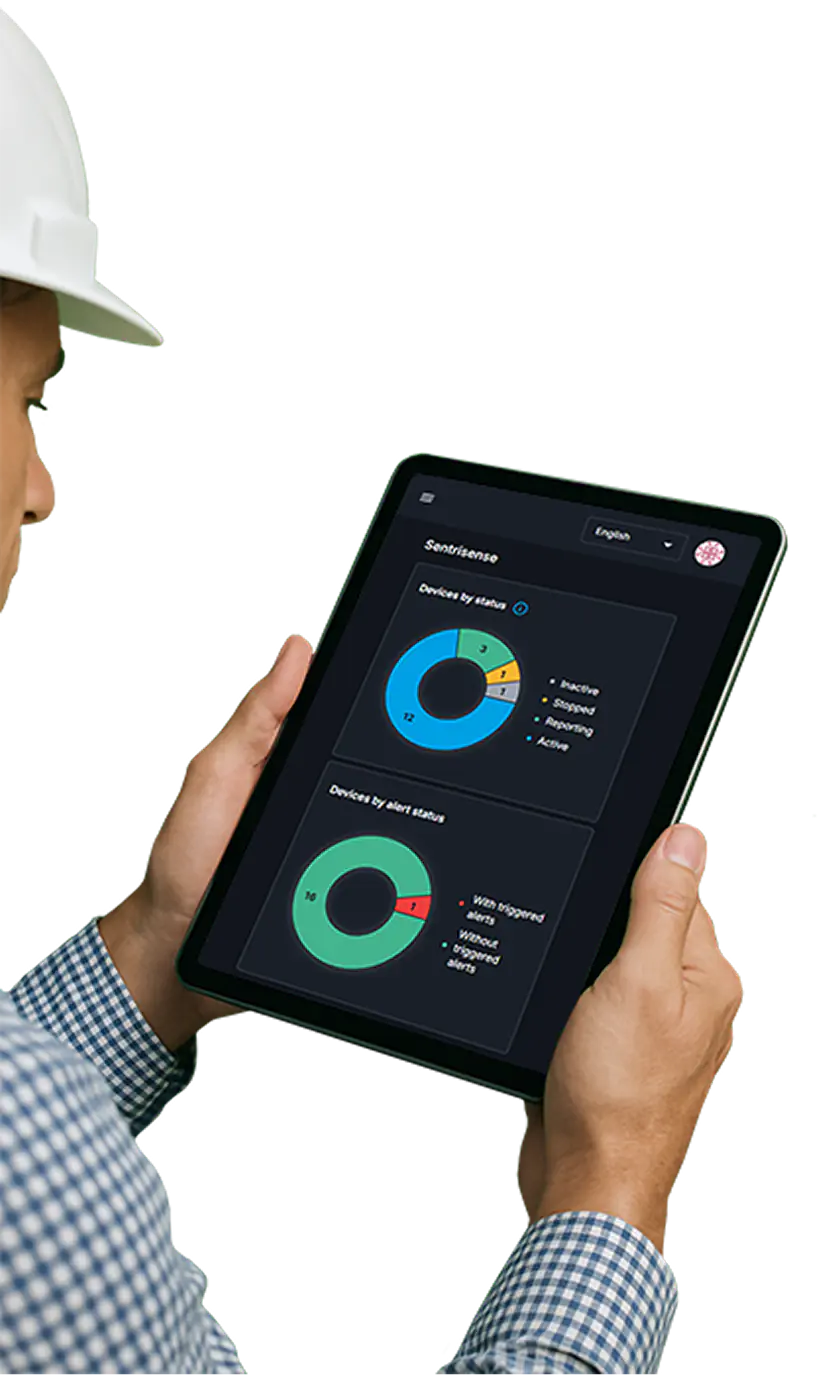 Man holding a tablet viewing the sentrisense dashboard